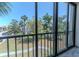 Scenic view from the balcony overlooking lush greenery and a glimpse of the surrounding neighborhood at 3281 Beneva Rd # 202, Sarasota, FL 34232