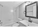 Clean bathroom with modern fixtures, including a white vanity and shower-tub combo at 3281 Beneva Rd # 202, Sarasota, FL 34232