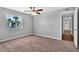 This bedroom offers natural light, neutral wall color, and an open doorway at 3281 Beneva Rd # 202, Sarasota, FL 34232