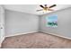 An empty bedroom features a scenic view from the window and a ceiling fan at 3281 Beneva Rd # 202, Sarasota, FL 34232