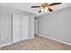 This cozy bedroom showcases carpeted floors, a ceiling fan, and a closet with standard doors at 3281 Beneva Rd # 202, Sarasota, FL 34232