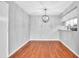 Bright dining area features hardwood floors, a modern light fixture, and views to kitchen at 3281 Beneva Rd # 202, Sarasota, FL 34232