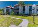Inviting exterior of a condominium featuring well-maintained landscaping and a charming walkway leading to the entrance at 3281 Beneva Rd # 202, Sarasota, FL 34232