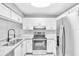 Updated kitchen featuring stainless steel appliances and white cabinetry at 3281 Beneva Rd # 202, Sarasota, FL 34232