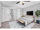 Spacious main bedroom with a ceiling fan, neutral walls, and an ensuite bathroom at 3281 Beneva Rd # 202, Sarasota, FL 34232