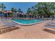 Community pool with surrounding lounge chairs and a brick-paved deck, perfect for relaxation and recreation at 3281 Beneva Rd # 202, Sarasota, FL 34232