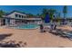 Outdoor pool area with tables, chairs, and lounge chairs for residents at 3281 Beneva Rd # 202, Sarasota, FL 34232