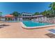 A bright, sunny outdoor pool area with several lounge chairs and tables at 3281 Beneva Rd # 202, Sarasota, FL 34232