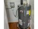 Close-up of a modern water heater unit with visible plumbing and electrical connections in a utility area at 3281 Beneva Rd # 202, Sarasota, FL 34232