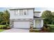Charming two-story home boasts stone accents and a welcoming front entry, enhancing curb appeal at 5220 Salt Marsh Rd, Wimauma, FL 33598