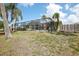 View of the home's enclosed patio and backyard at 5616 Riddle Rd, Holiday, FL 34690