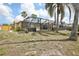 View of the home's enclosed patio and backyard at 5616 Riddle Rd, Holiday, FL 34690