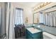 Bathroom with blue accents, including the vanity and window coverings at 5616 Riddle Rd, Holiday, FL 34690