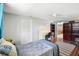 Bedroom with wood floors, a ceiling fan, desk and shelving, with a view into another room at 5616 Riddle Rd, Holiday, FL 34690