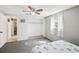 Bright bedroom with a ceiling fan, closet and a window with decorative stained glass at 5616 Riddle Rd, Holiday, FL 34690