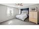 Comfortable bedroom with neutral tones, a ceiling fan, and soft natural light, offering a calming retreat at 5616 Riddle Rd, Holiday, FL 34690