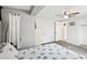 Bedroom with ceiling fan, neutral colors, and a glimpse into the ensuite bathroom, providing a tranquil space at 5616 Riddle Rd, Holiday, FL 34690