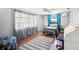 Cozy bedroom with wood floors, an accent rug, and natural light from a large window at 5616 Riddle Rd, Holiday, FL 34690