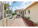 Charming front entry features a mosaic tile walkway, lush landscaping and a cozy porch at 5616 Riddle Rd, Holiday, FL 34690