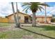 Charming single-Gathering home with mature palm trees, well-kept lawn and inviting curb appeal at 5616 Riddle Rd, Holiday, FL 34690