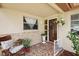 Cozy front porch featuring mosaic tile flooring, a comfortable rocking chair and charming decor at 5616 Riddle Rd, Holiday, FL 34690