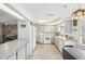 Well-lit kitchen with tile flooring, plentiful white cabinetry, and a complete appliance package at 5616 Riddle Rd, Holiday, FL 34690