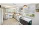 Functional kitchen with appliances and window overlooking exterior view and breakfast table at 5616 Riddle Rd, Holiday, FL 34690