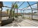 Spacious screened lanai offers outdoor seating and peaceful waterfront views, perfect for relaxing at 5616 Riddle Rd, Holiday, FL 34690