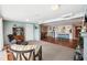 Open-concept living room with a decorative cabinet and a seamless transition to the adjacent dining area at 5616 Riddle Rd, Holiday, FL 34690