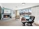 Relaxing living room features a fireplace, comfortable chair, and scenic views of the pool and waterway at 5616 Riddle Rd, Holiday, FL 34690