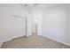 Bedroom features a closet, ceiling fan and wood-look floors at 7001 Cohasset Cir, Riverview, FL 33578