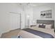 Staged bedroom with neutral decor, ceiling fan, closet and wood-look floors at 7001 Cohasset Cir, Riverview, FL 33578