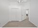 Bedroom features a closet, ceiling fan and wood-look floors at 7001 Cohasset Cir, Riverview, FL 33578