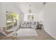 Bright living room with neutral tones, vaulted ceiling, and large windows at 7001 Cohasset Cir, Riverview, FL 33578