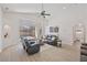 Bright living room with vaulted ceilings, laminate flooring, and sliding glass doors to pool at 7001 Cohasset Cir, Riverview, FL 33578