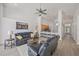 Open-concept living space with modern furnishings and seamless flow to the kitchen area at 7001 Cohasset Cir, Riverview, FL 33578