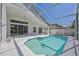 Screened-in swimming pool with a small sea turtle emblem on the bottom and a covered lanai at 7001 Cohasset Cir, Riverview, FL 33578
