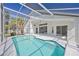 Screened-in swimming pool with attached covered patio, great for outdoor entertaining at 7001 Cohasset Cir, Riverview, FL 33578