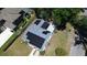 Aerial view of home with solar panels and mature trees, emphasizing green energy and privacy at 701 W Idlewild Ave, Tampa, FL 33604