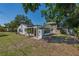 Backyard featuring a well maintained lawn and white exterior of home at 701 W Idlewild Ave, Tampa, FL 33604