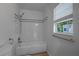 Bathroom featuring a shower with white subway tile, providing a clean and classic aesthetic at 701 W Idlewild Ave, Tampa, FL 33604