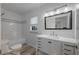Bright bathroom featuring a modern vanity with stylish hardware and a shower with subway tile surround at 701 W Idlewild Ave, Tampa, FL 33604