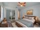 Comfortable bedroom featuring wood floors, natural light, and decorative furnishings at 701 W Idlewild Ave, Tampa, FL 33604