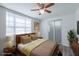 Staged bedroom with a ceiling fan, closet, and stylish decor at 701 W Idlewild Ave, Tampa, FL 33604