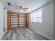 Spacious bedroom with wood floors and built-in shelving for storage at 701 W Idlewild Ave, Tampa, FL 33604