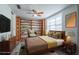 Cozy bedroom with built-in shelving, neutral tones, and a ceiling fan at 701 W Idlewild Ave, Tampa, FL 33604