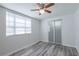 Bright bedroom featuring wood floors, natural light, and sliding closet doors at 701 W Idlewild Ave, Tampa, FL 33604