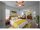 Staged bedroom with modern decor, wood floor, ceiling fan and ensuite bathroom at 701 W Idlewild Ave, Tampa, FL 33604