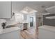 Modern kitchen featuring white cabinetry, stainless steel appliances, and a skylight at 701 W Idlewild Ave, Tampa, FL 33604