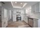 Updated kitchen with white cabinets, stainless steel appliances, and a skylight at 701 W Idlewild Ave, Tampa, FL 33604